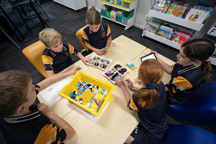 Students working together to create lego robot.