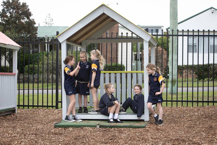 Students playing in cubby house.
