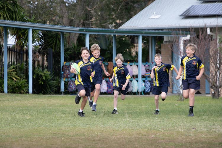 Students playing football outdoors