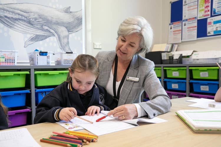 teacher working with student