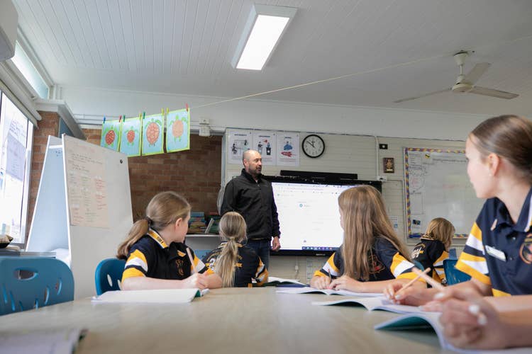 Teacher teaching clas working at their desks