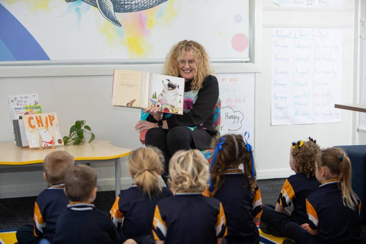 Teacher reading class a book