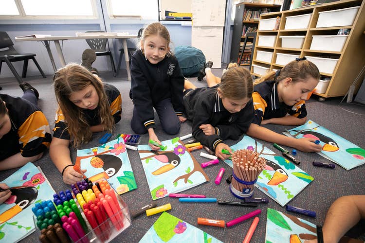 Students on carpet doing art activity