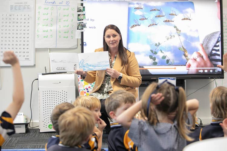 Teacher reading to group of students