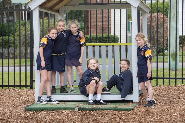 Students playing in cubby house
